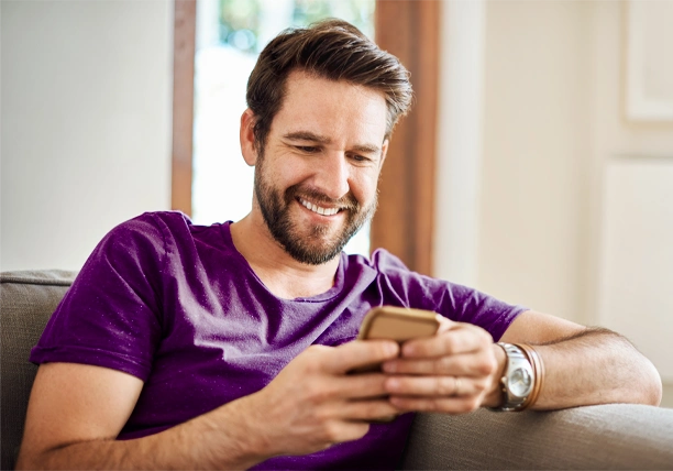 A man uses a smartphone to review his bank accounts.