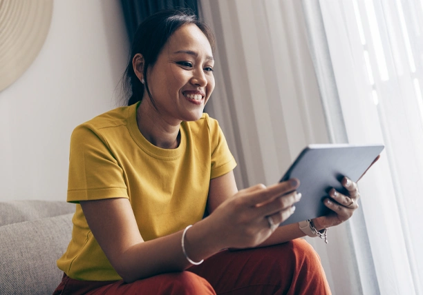 A woman uses a tablet to explore different banking options.