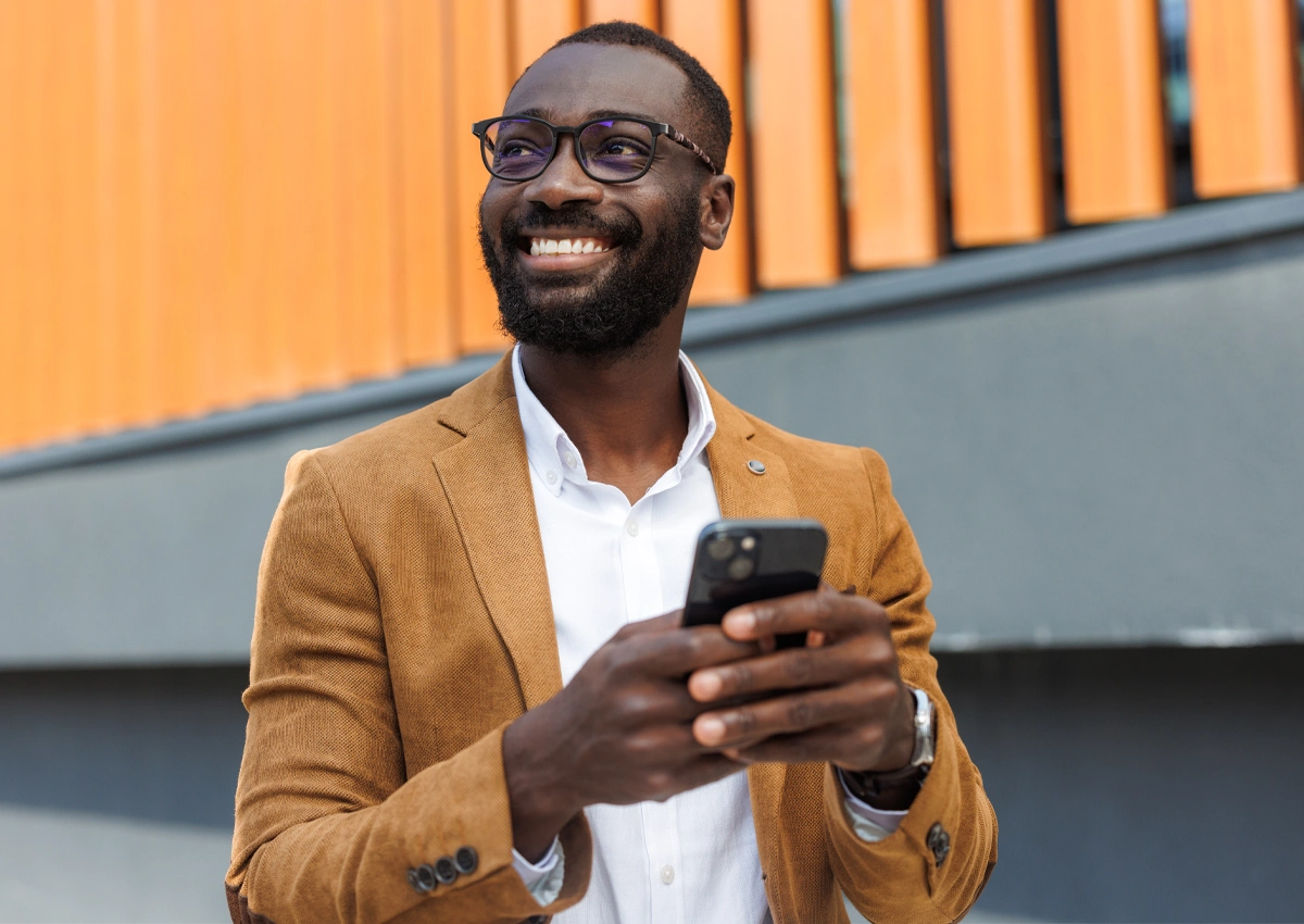 Person using a phone to get support for building savings habits.