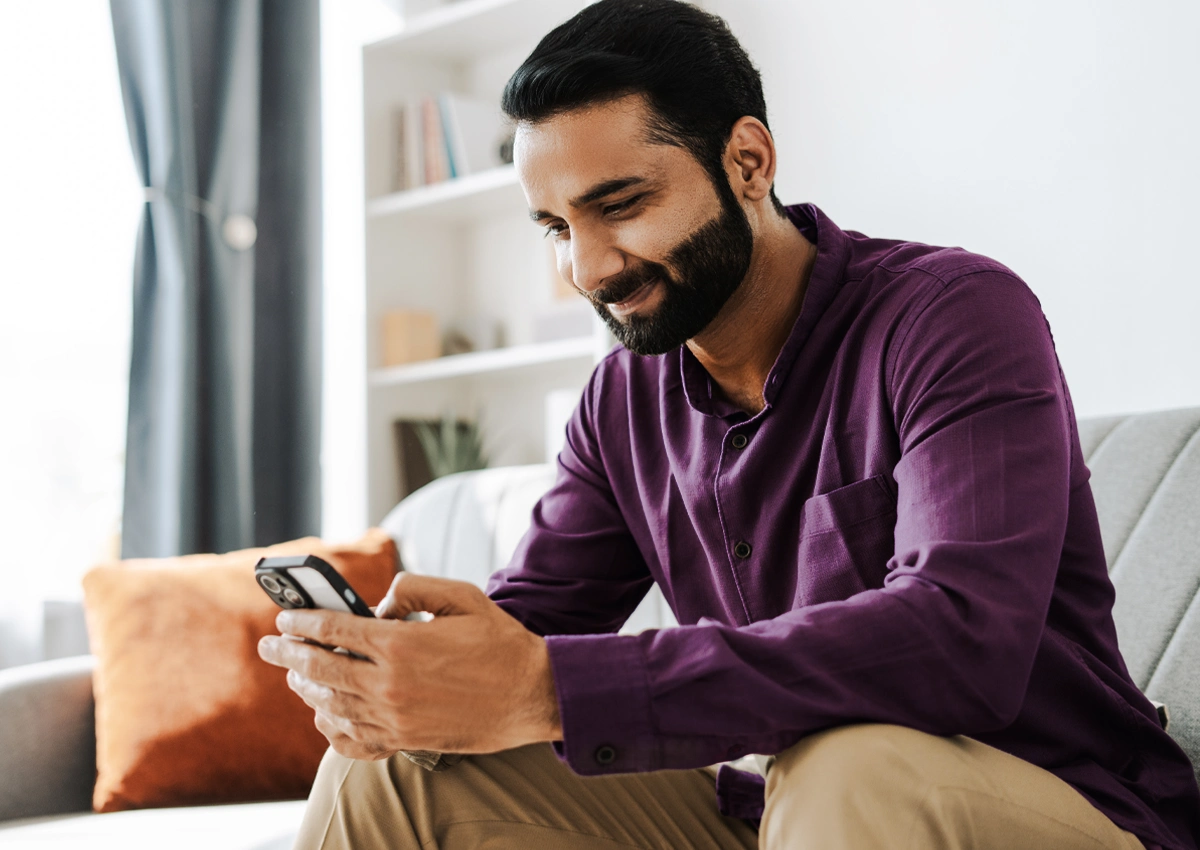Person using a phone to learn money basics at their own pace.