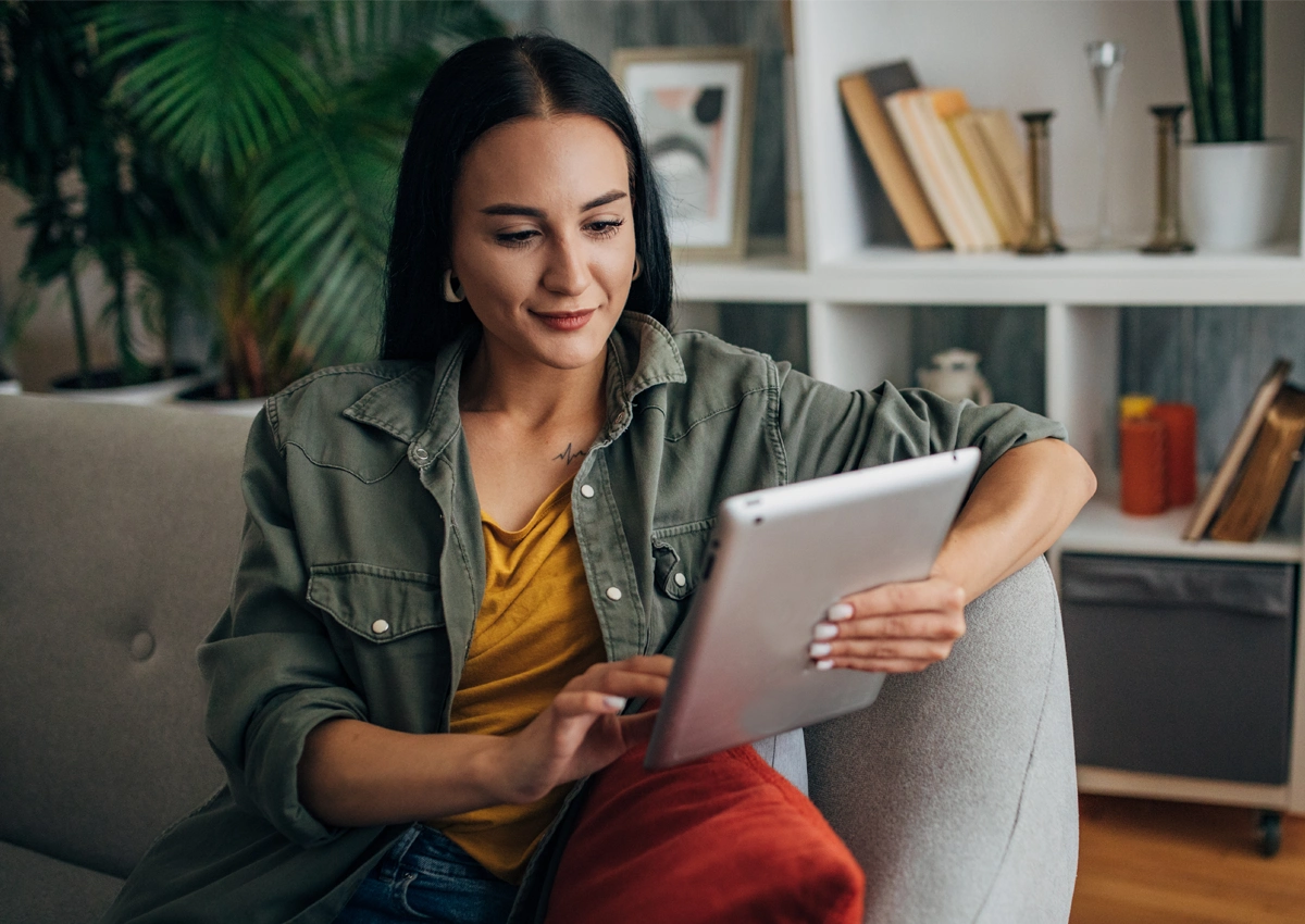 Person using a tablet to get support for managing spending goals.