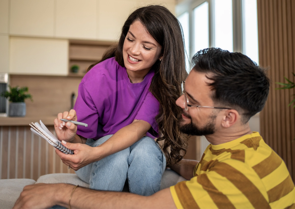 A couple reviewing their financial information and goals together.