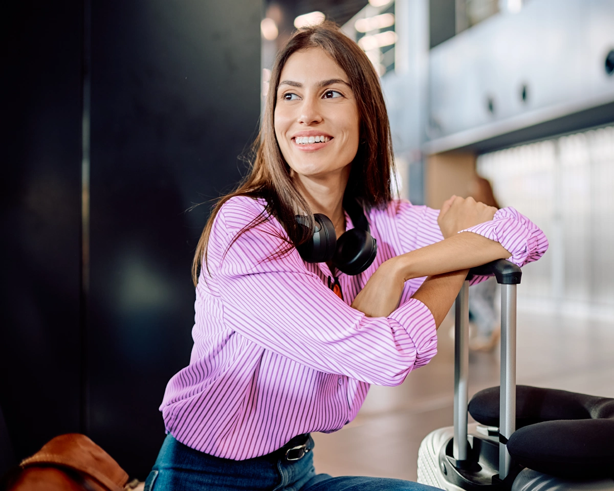 Person at airport looking confident in what comes next.