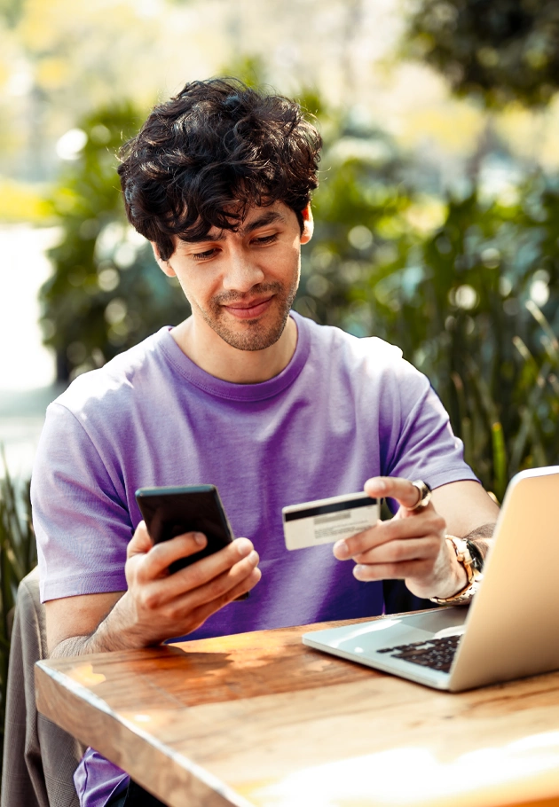 A young man uses his phone to review his finances.