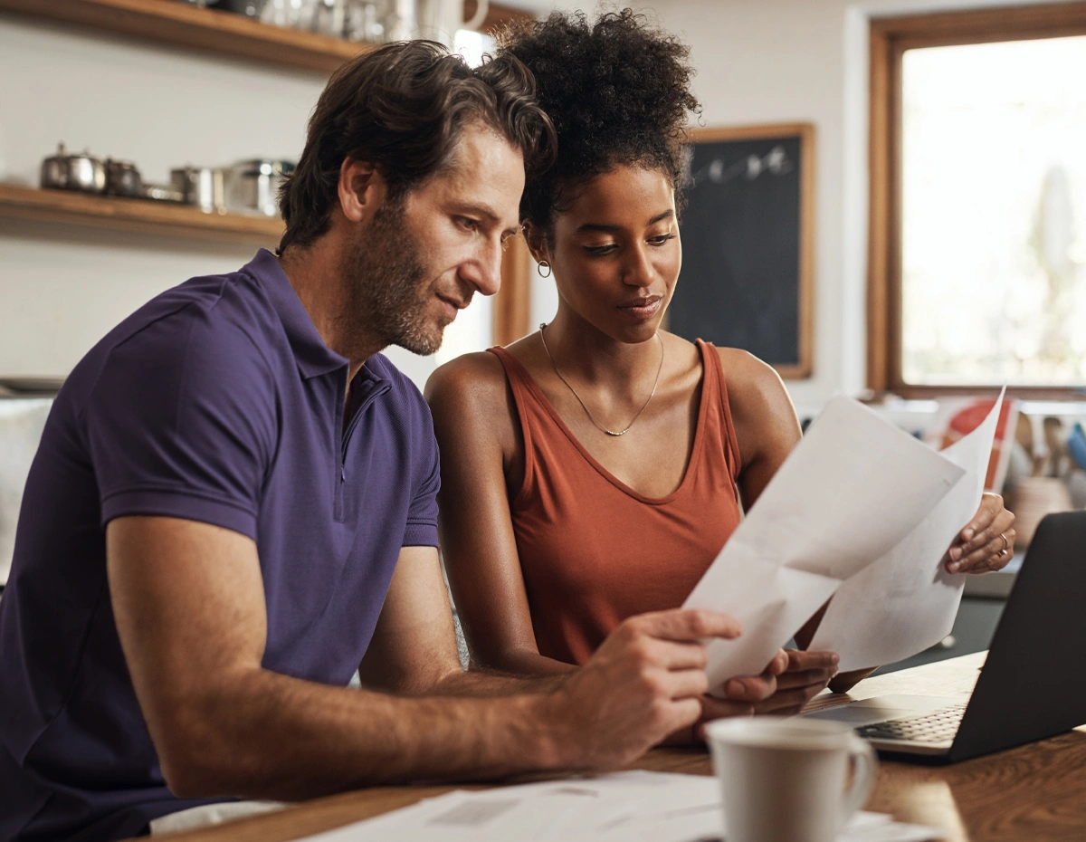 Two people reviewing information together before starting financial coaching.