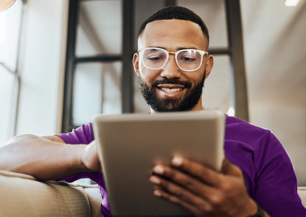 A man researches financial help options on a tablet.
