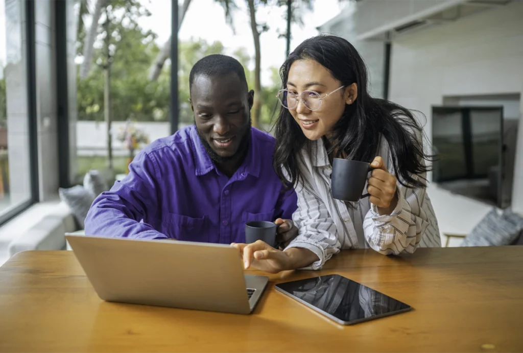 Two people reviewing their finances together on a laptop computer.