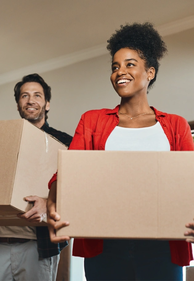 Two people looking confident as they handle moving boxes.